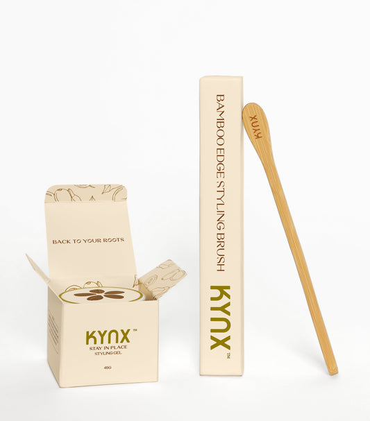 A toothbrush made of bamboo, with its packaging, on a white background. The packaging has the brand name 'KYNX' printed on it.